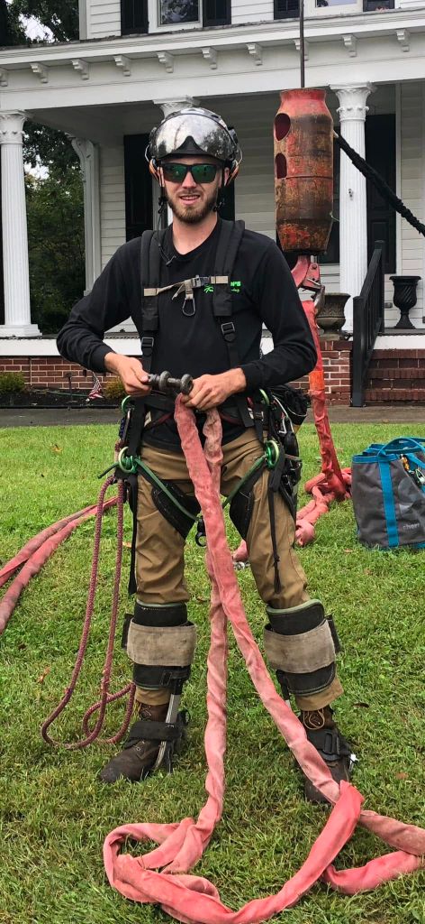 Garrison's Tree Service climber wearing full rigging and climbing gear